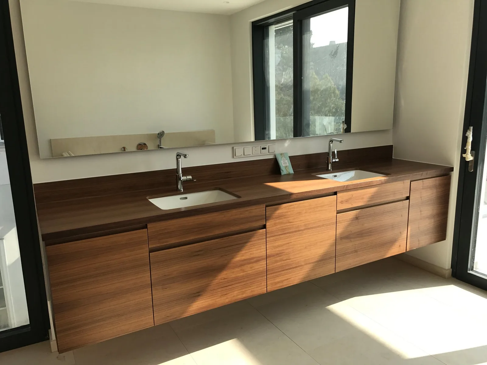 Hängender Waschtisch-Unterschrank aus dunklem Holz mit zwei Becken